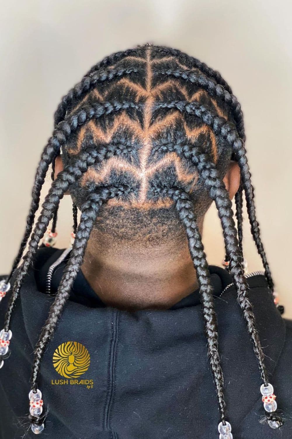 A man with zigzag cornrows with beads.