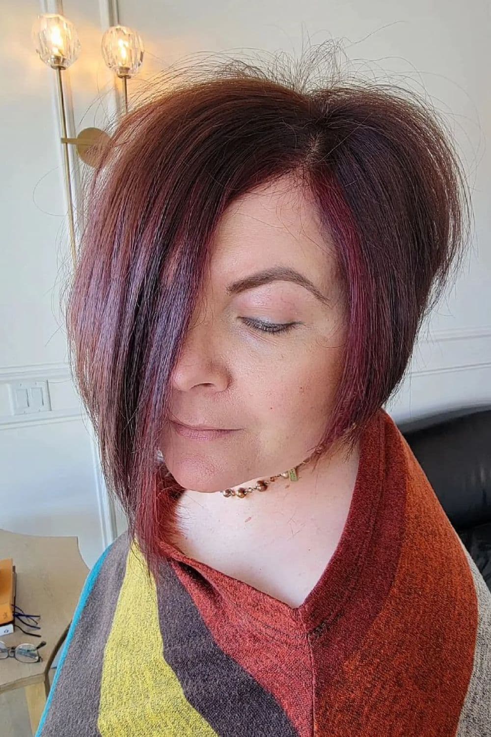 A woman with a red asymmetrical bixie cut.