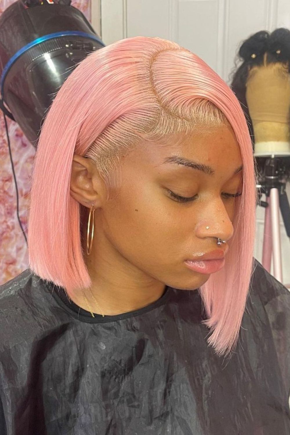 A woman with a pink asymmetrical bob cut.