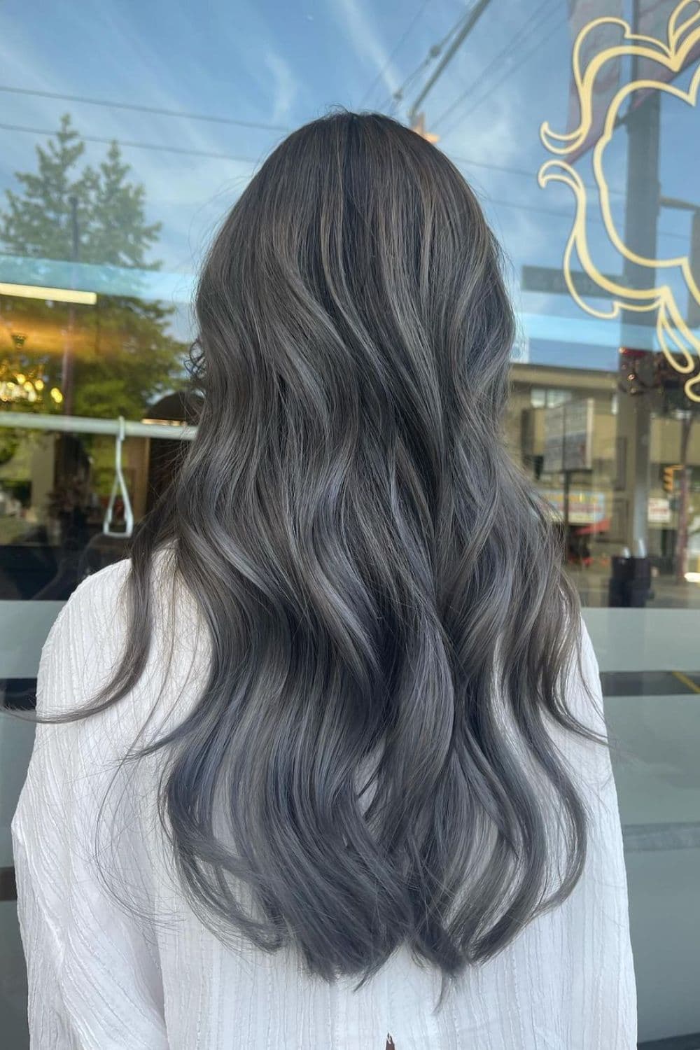 A woman with long balayage ombre hair.