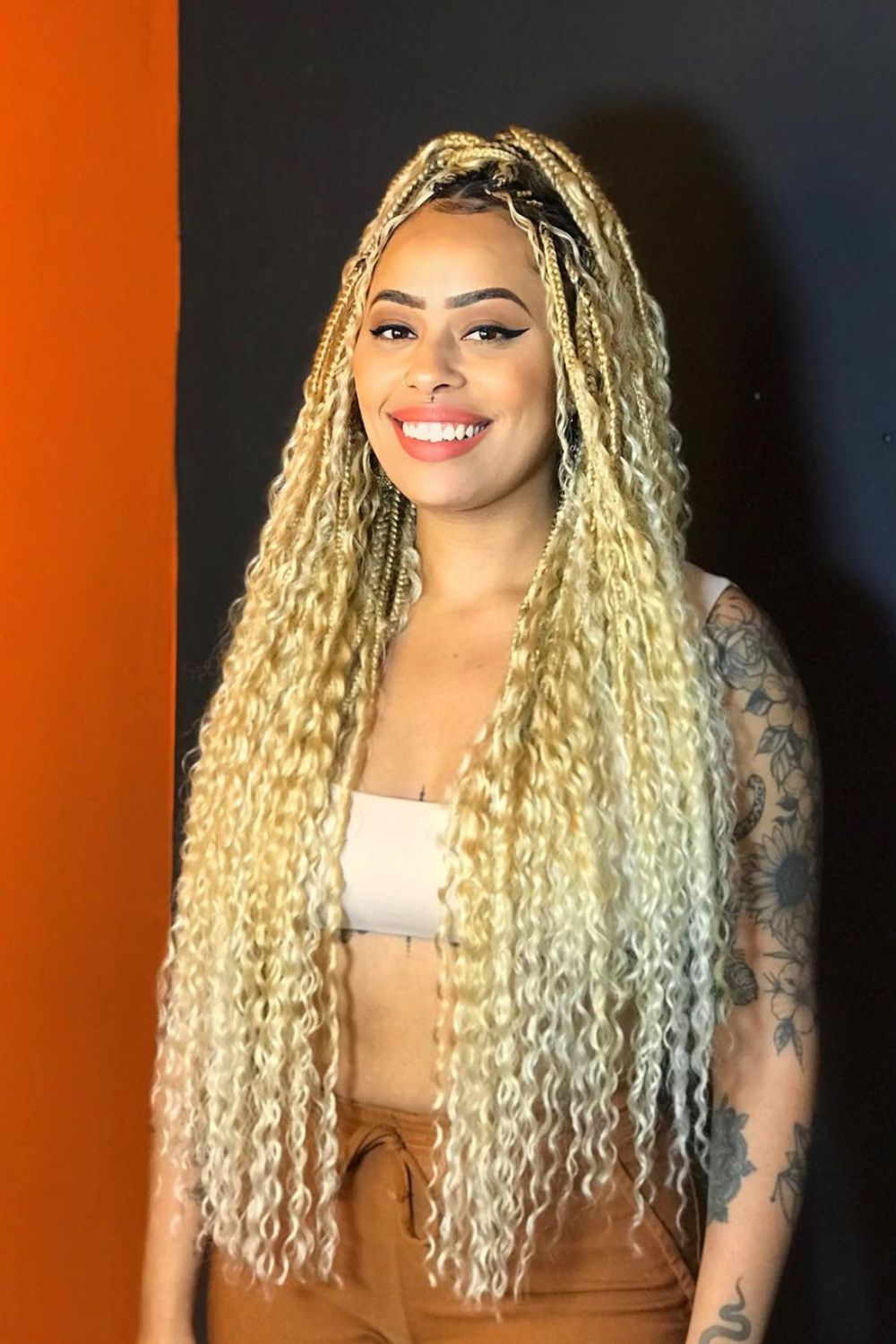 A woman with long blonde goddess braids.