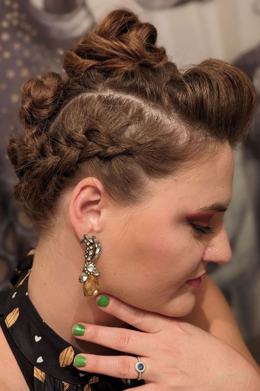 A woman with brown braided faux hawk updo.