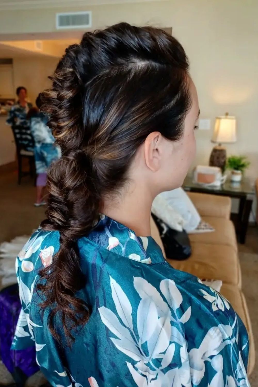 A woman with a brown braided faux hawk.