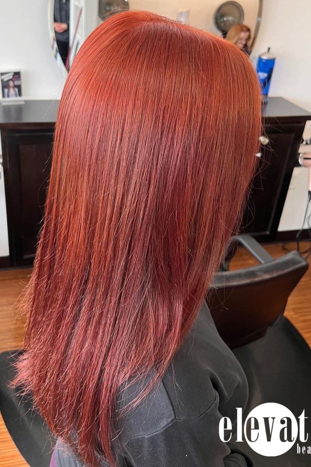 A woman with long straight brick red hair.