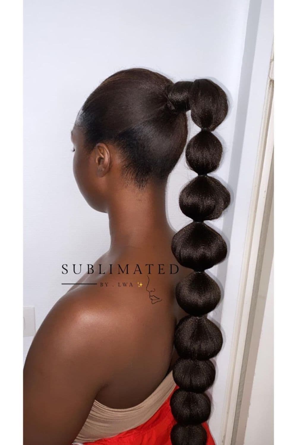 A woman with long 4C bubble ponytail.