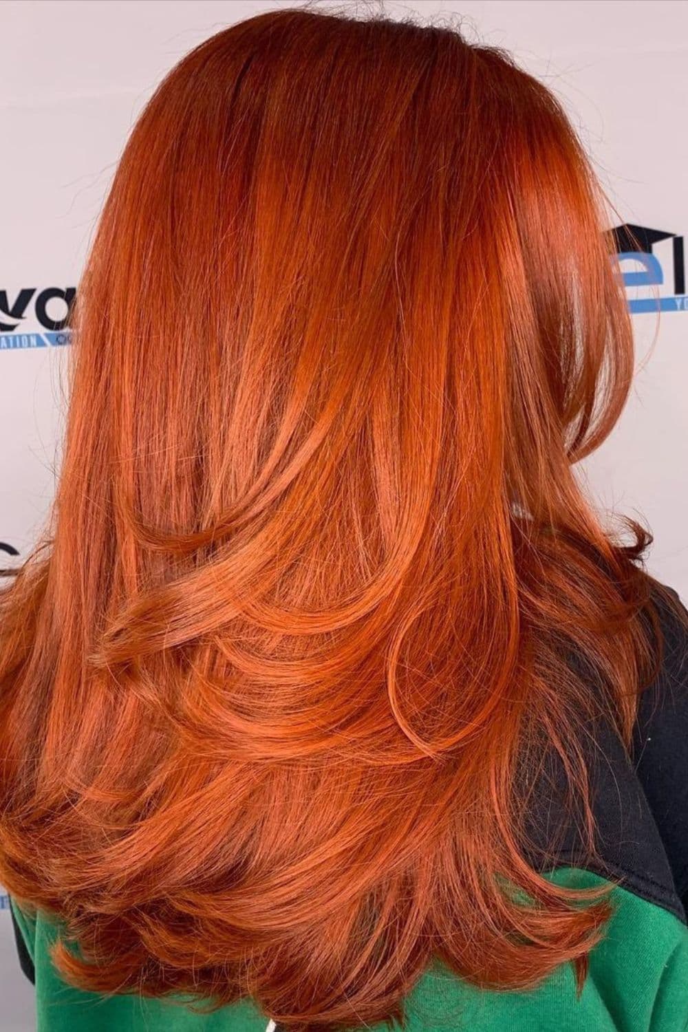 A woman with a long thick burnt orange hair.
