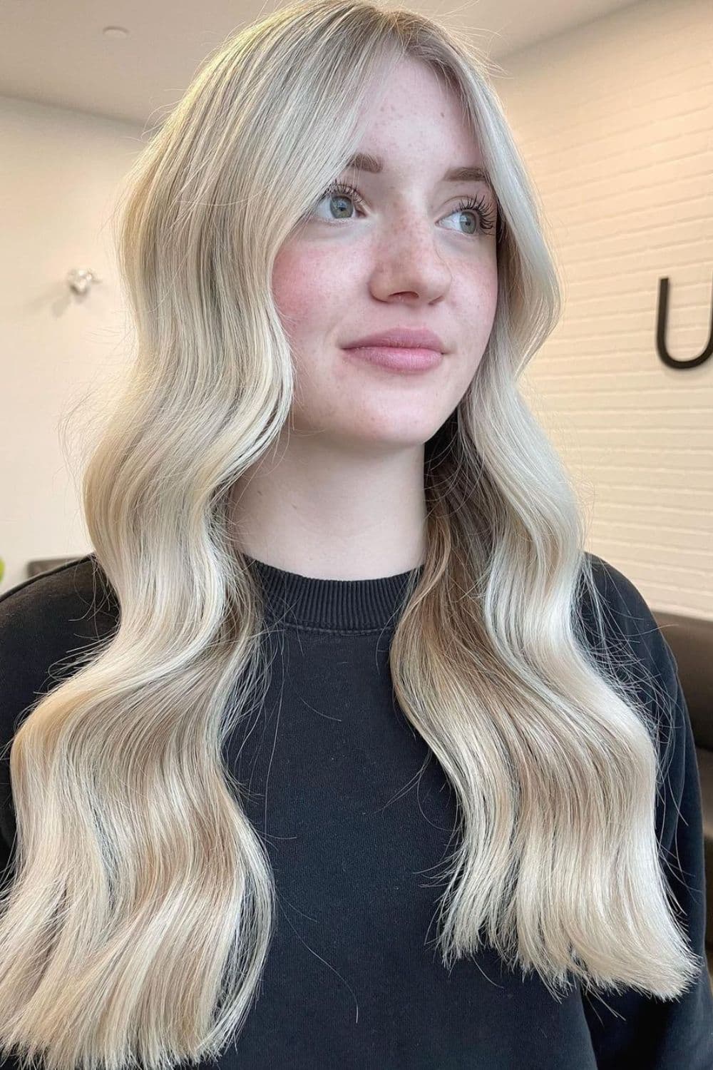 A woman with a long wavy champagne blonde.