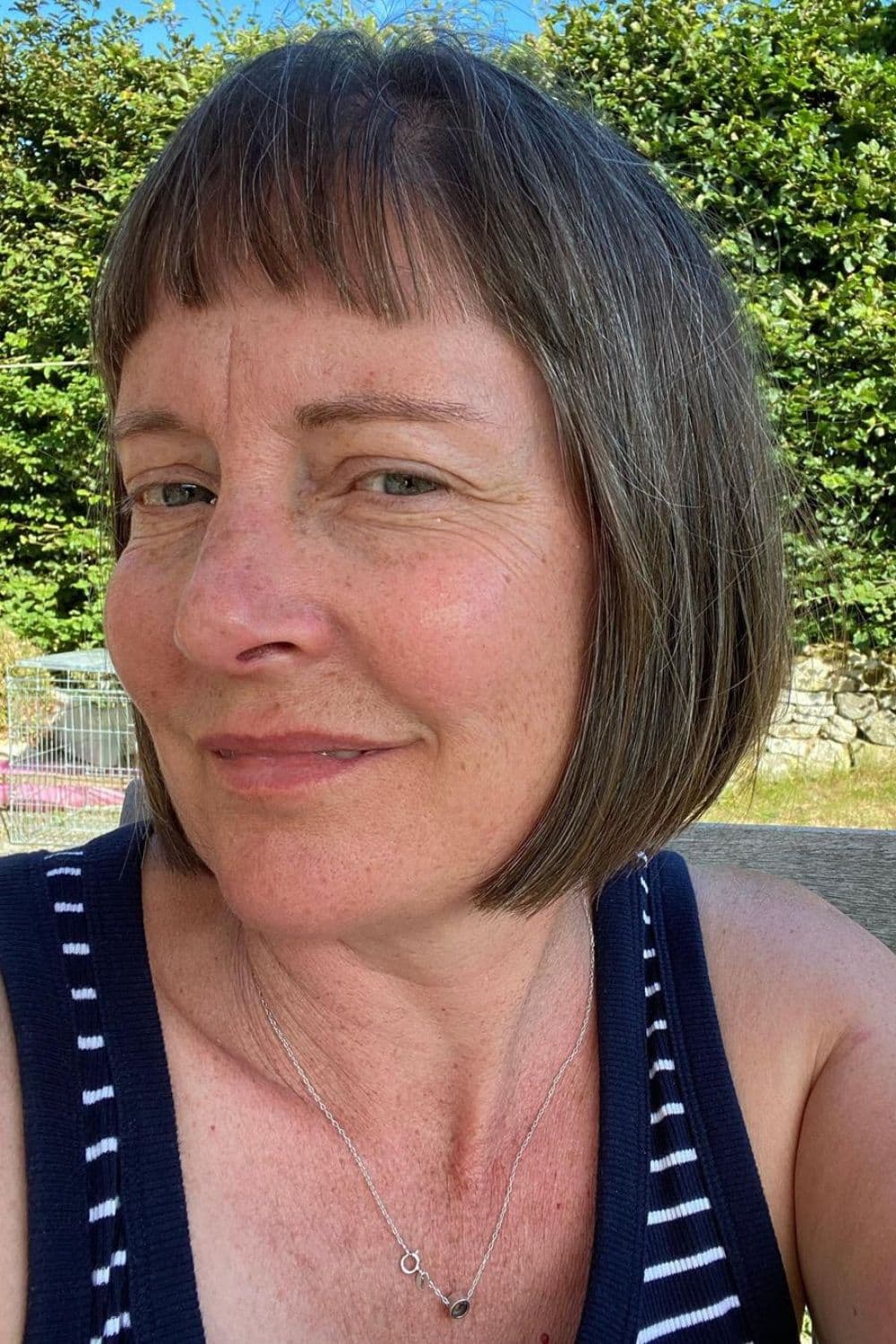 A woman with a chin-length bob cut with choppy bangs.
