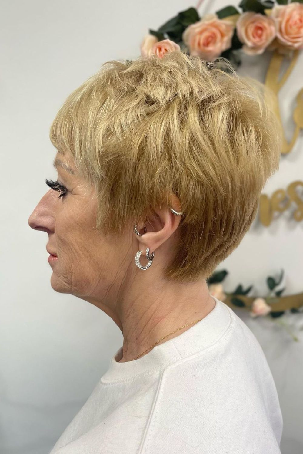 A woman with a blonde choppy pixie cut.