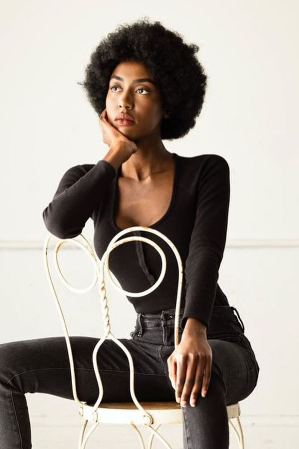 A black woman with a classic Afro hairstyle.