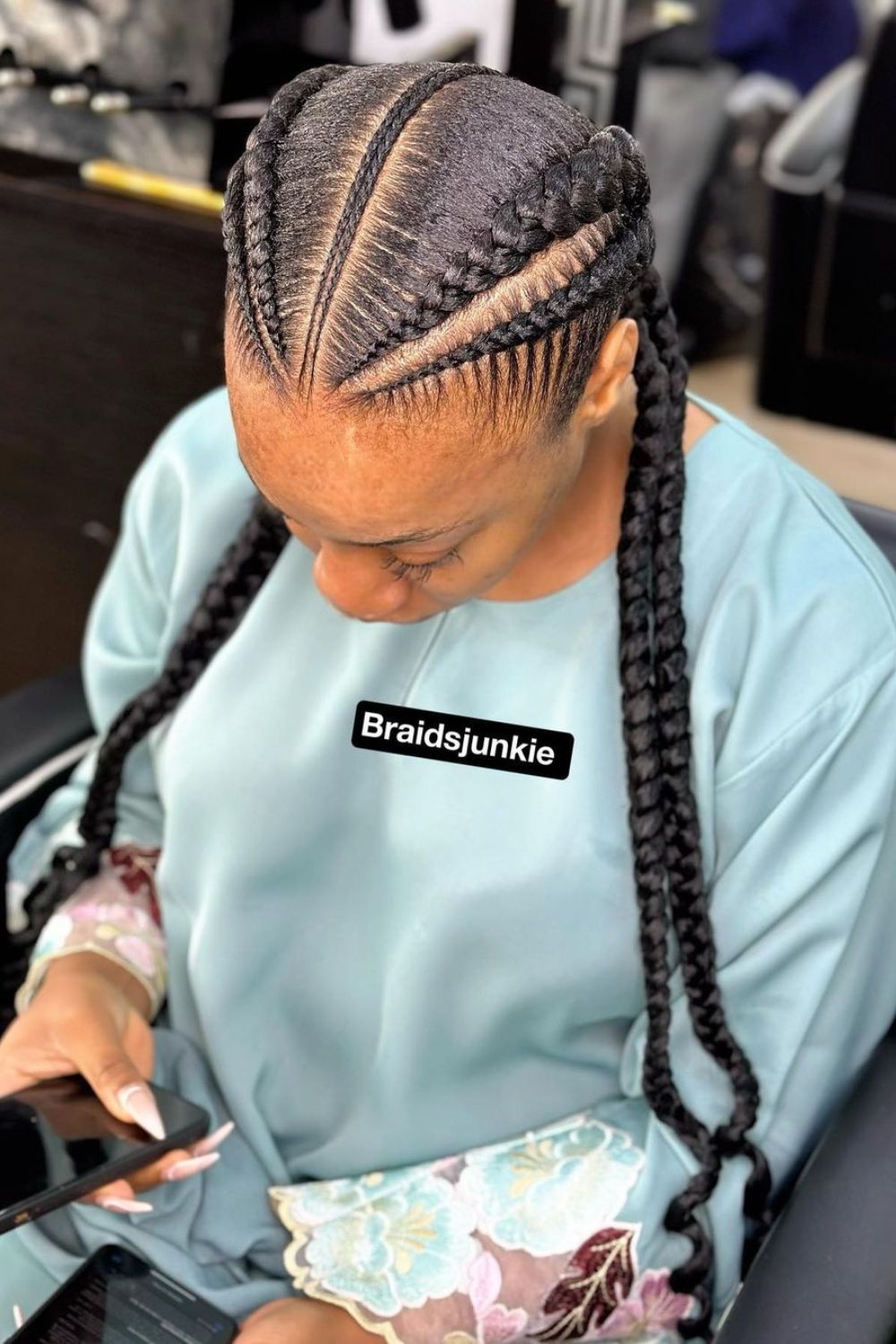 A woman with cornrows hairstyle.