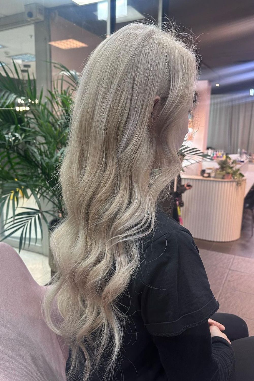 A woman with long curled cream blonde hair.