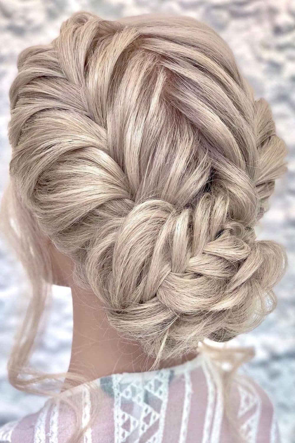 A mannequin with a blonde crimped braided updo.
