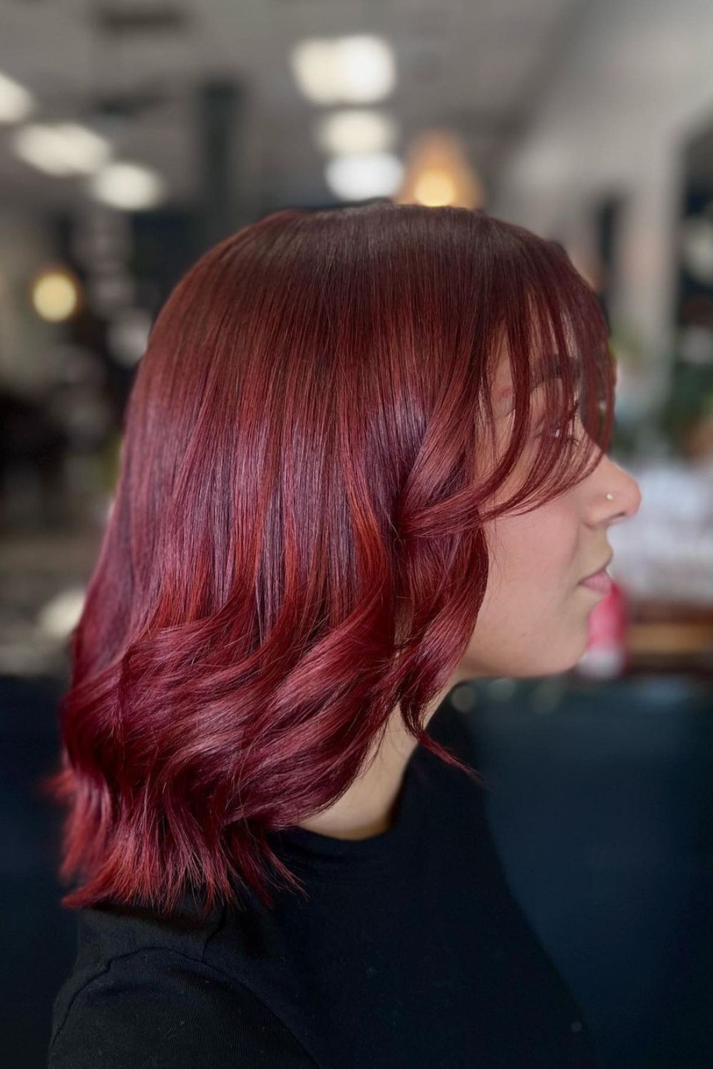 A woman with a red crimson lob hair.
