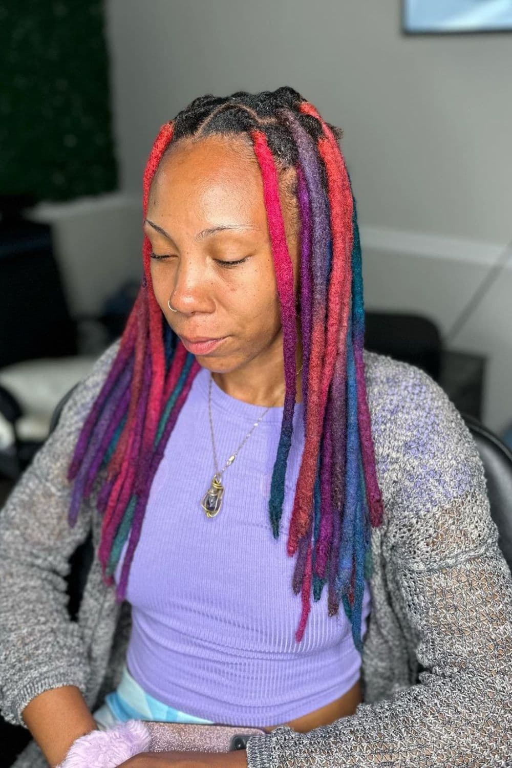 A woman with colorful crochet locs.