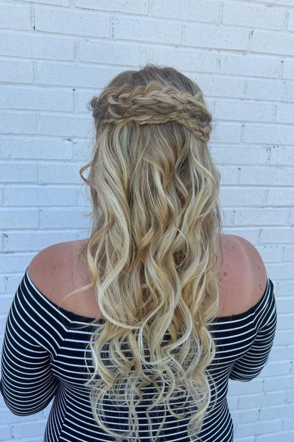 A woman with long blonde crown braid.