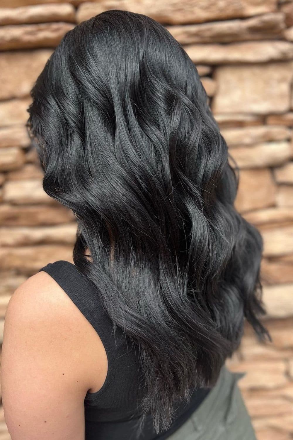 A woman with long deep blue black hair.