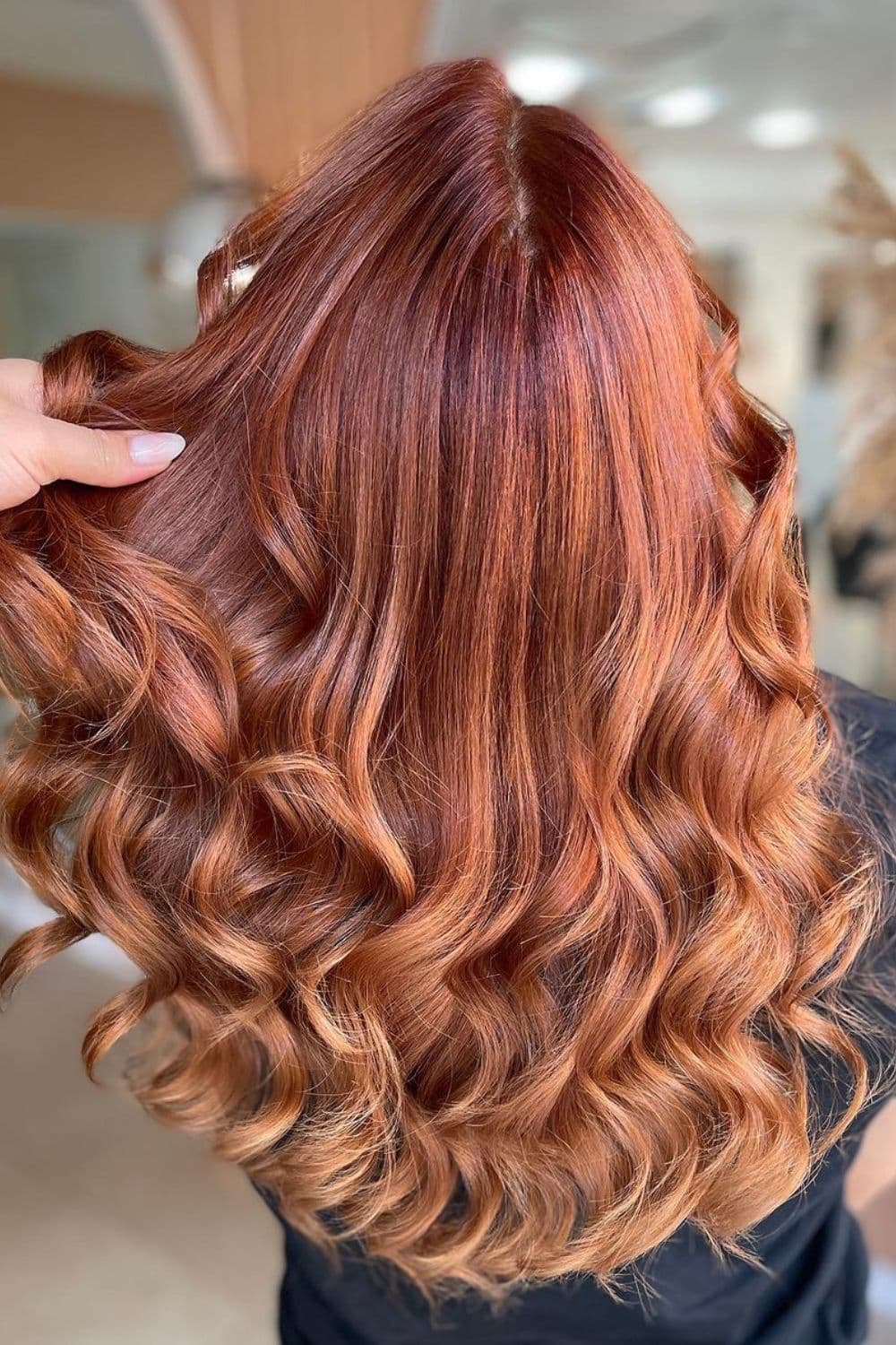 A woman with deep cinnamon hair.