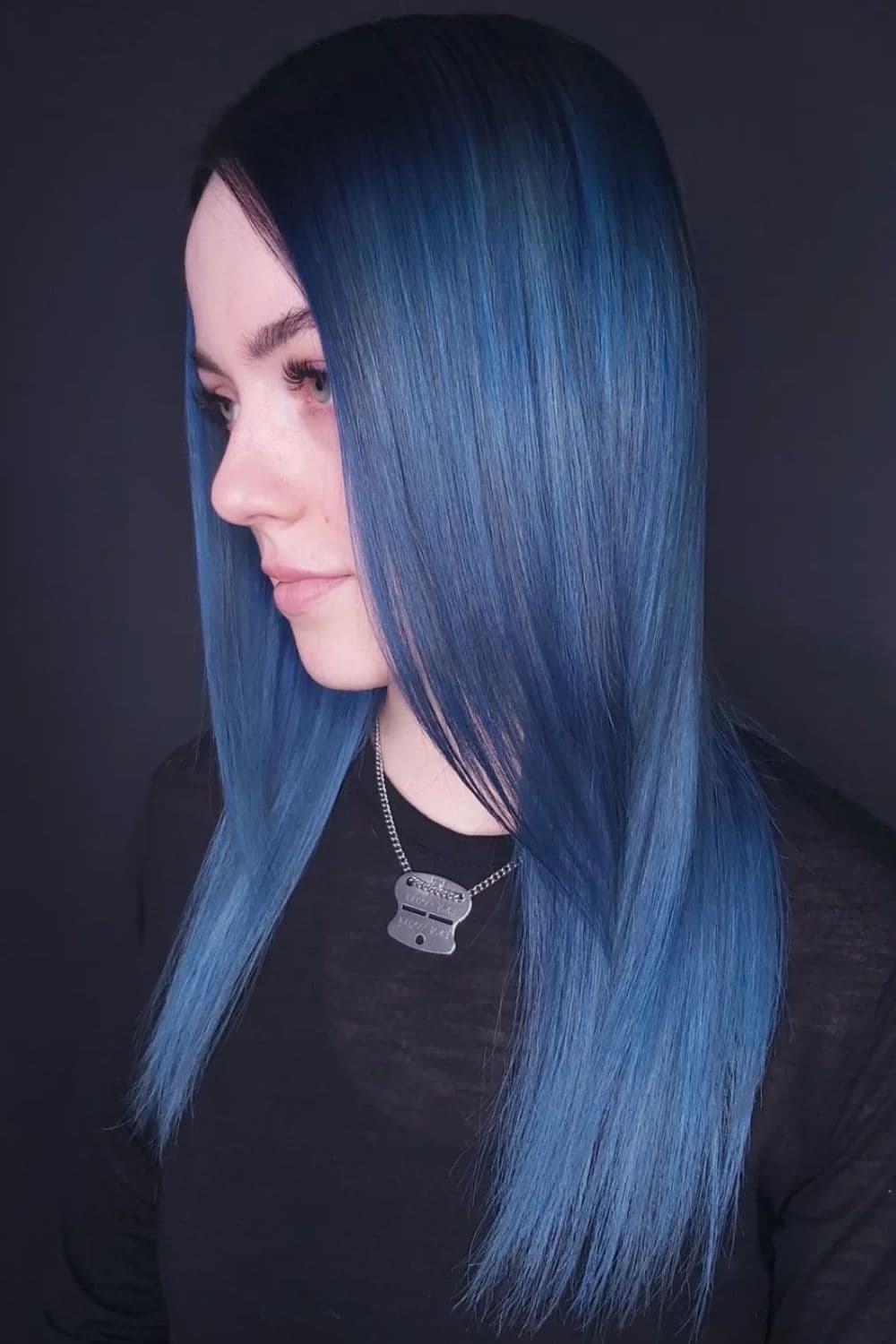 A woman with long straight denim blue hair.