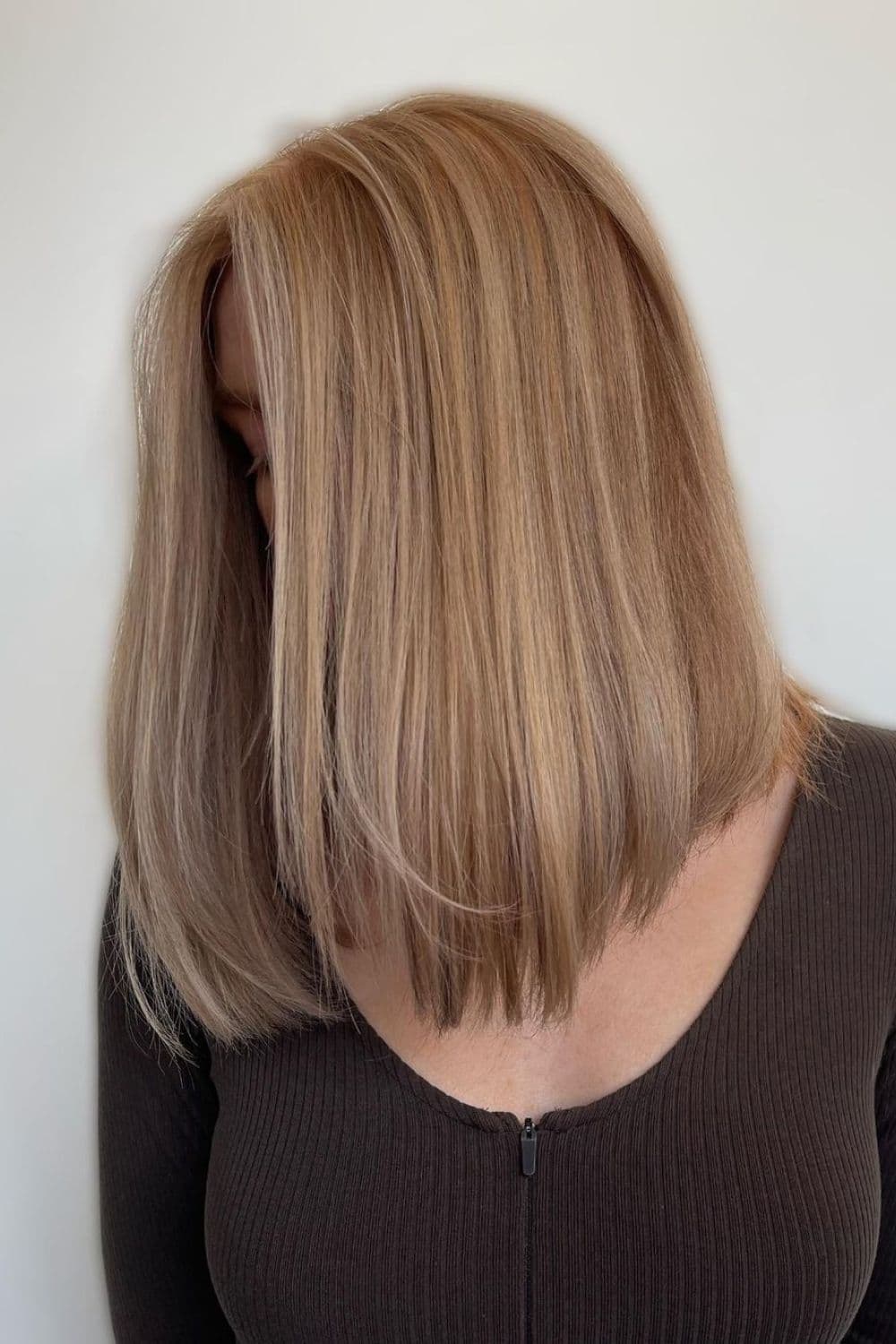 A woman with dirty strawberry blonde long bob.