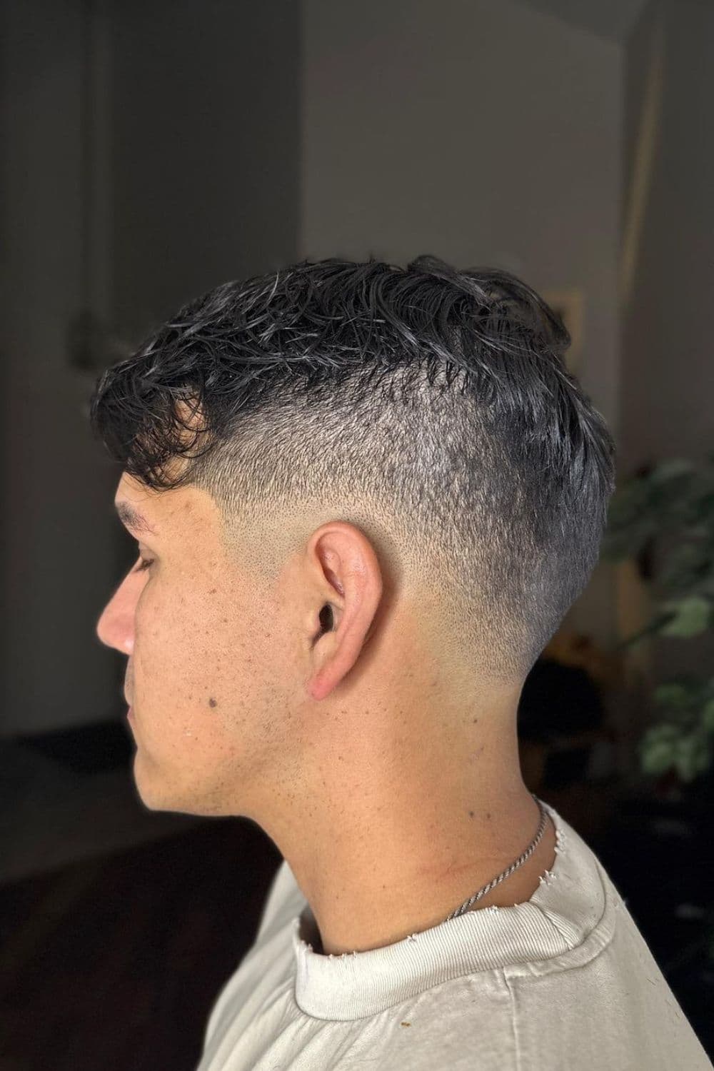 Side view of a man with a drop fade cut.