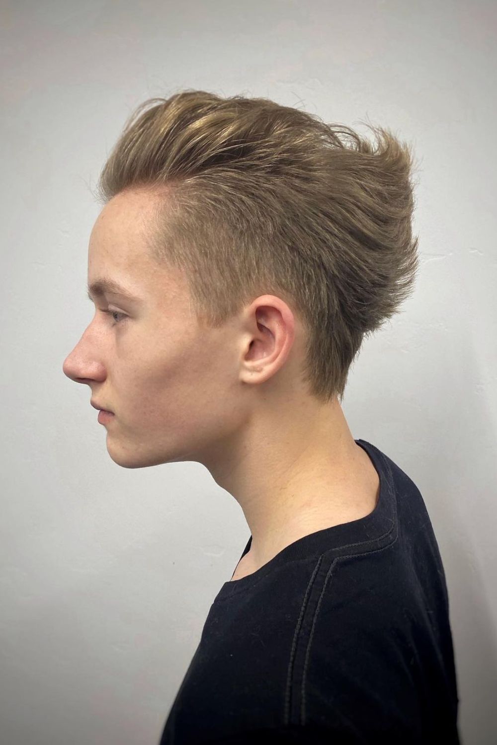 A man with a blonde ducktail cut.