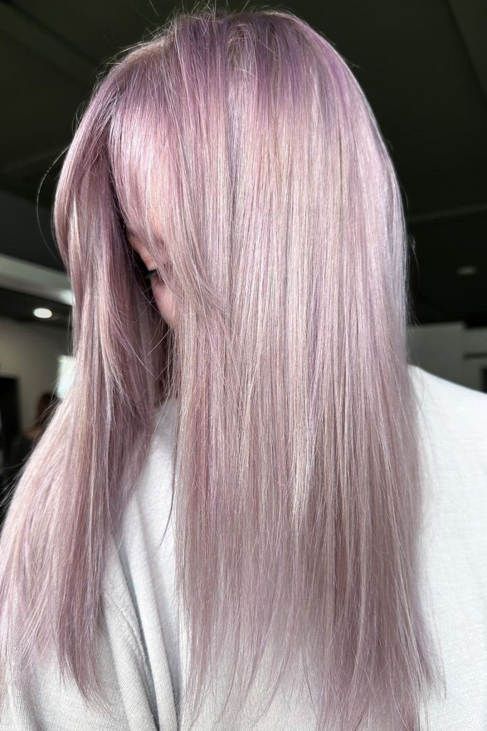 A woman with long straight dusty lilac hair.