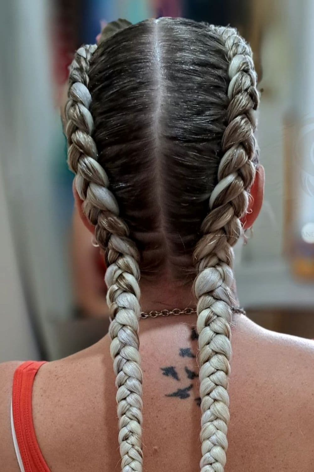 A woman with a blonde double Dutch braid.