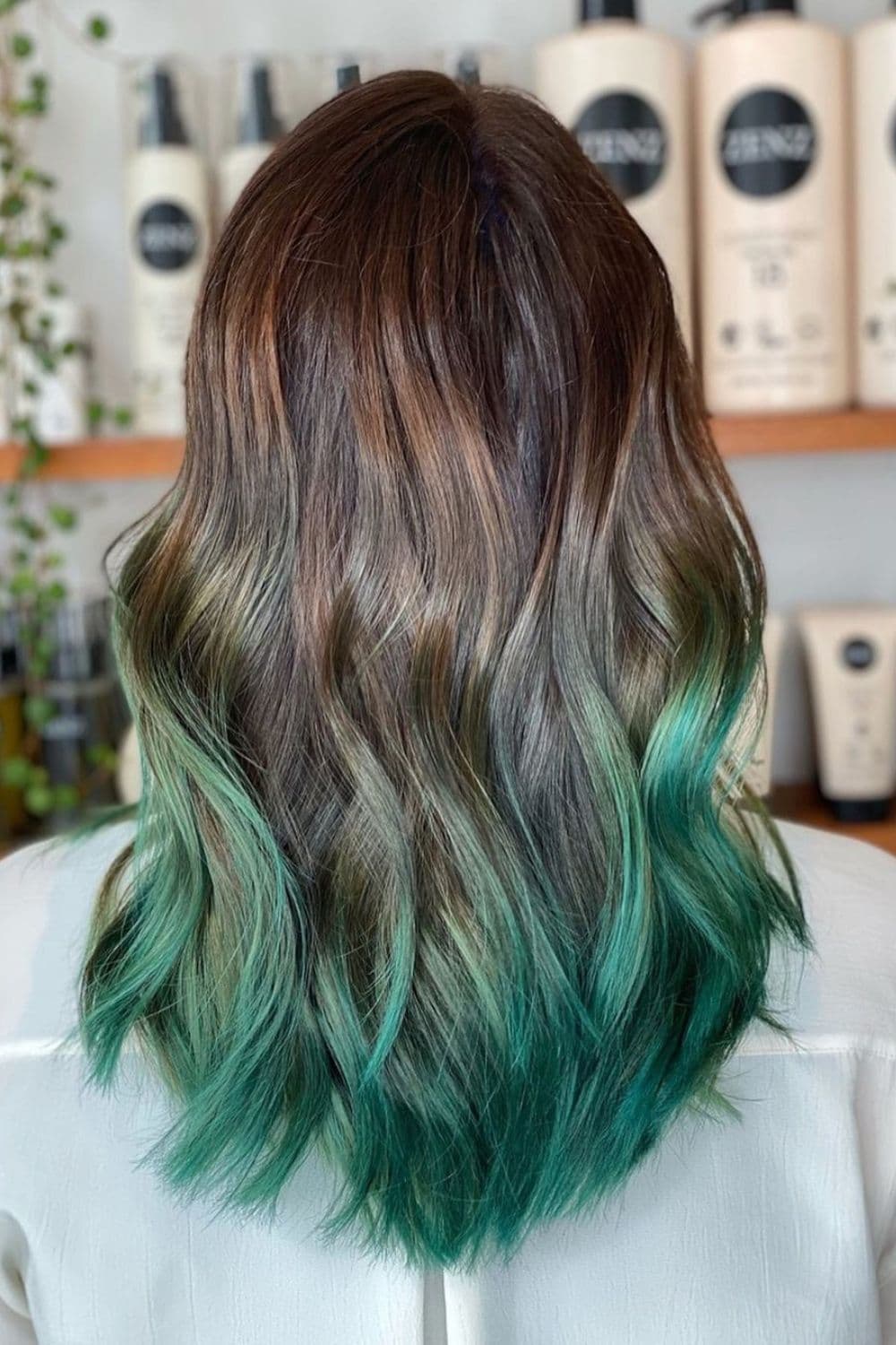 A woman with emerald green ombre hair.