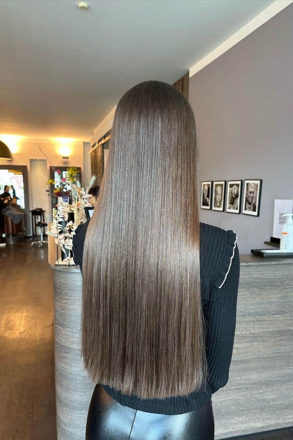 A woman with long straight espresso brown hair.