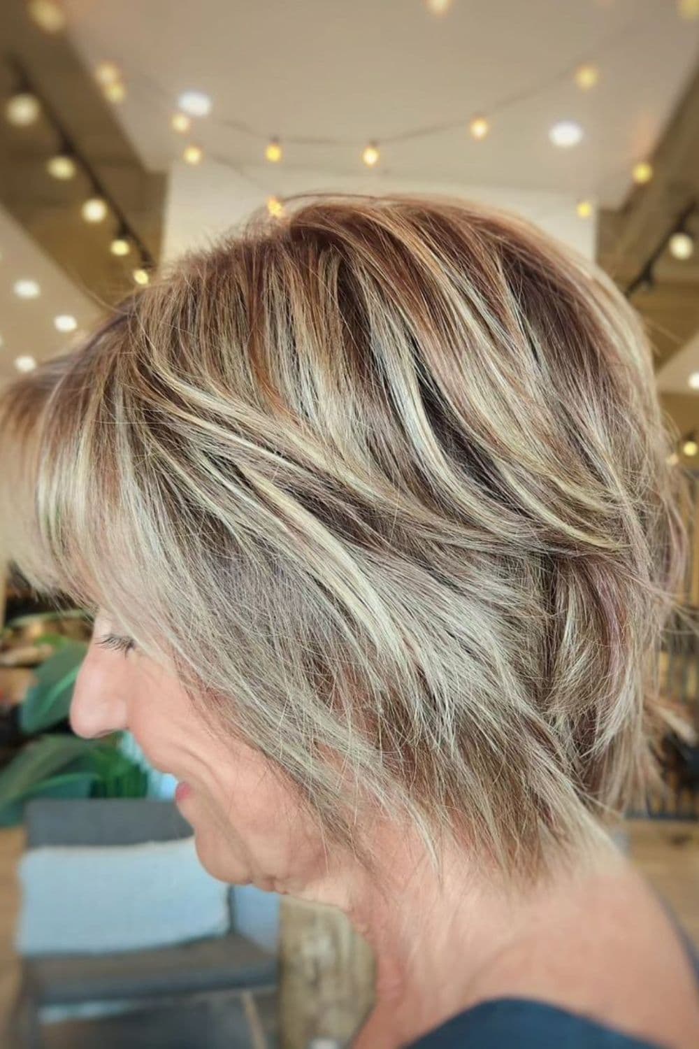 A woman with a feathered bixie cut.