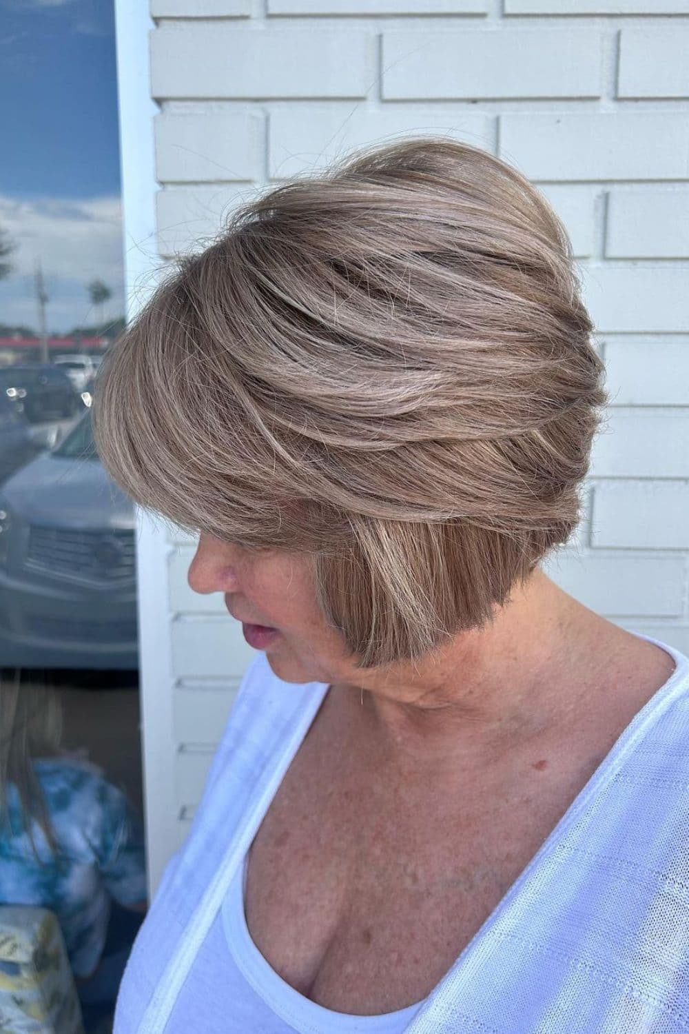 A woman with a feathered inverse bob cut.