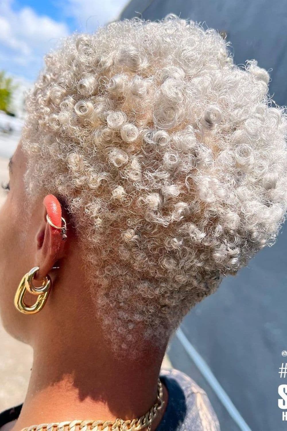 A woman with short blonde finger coils.