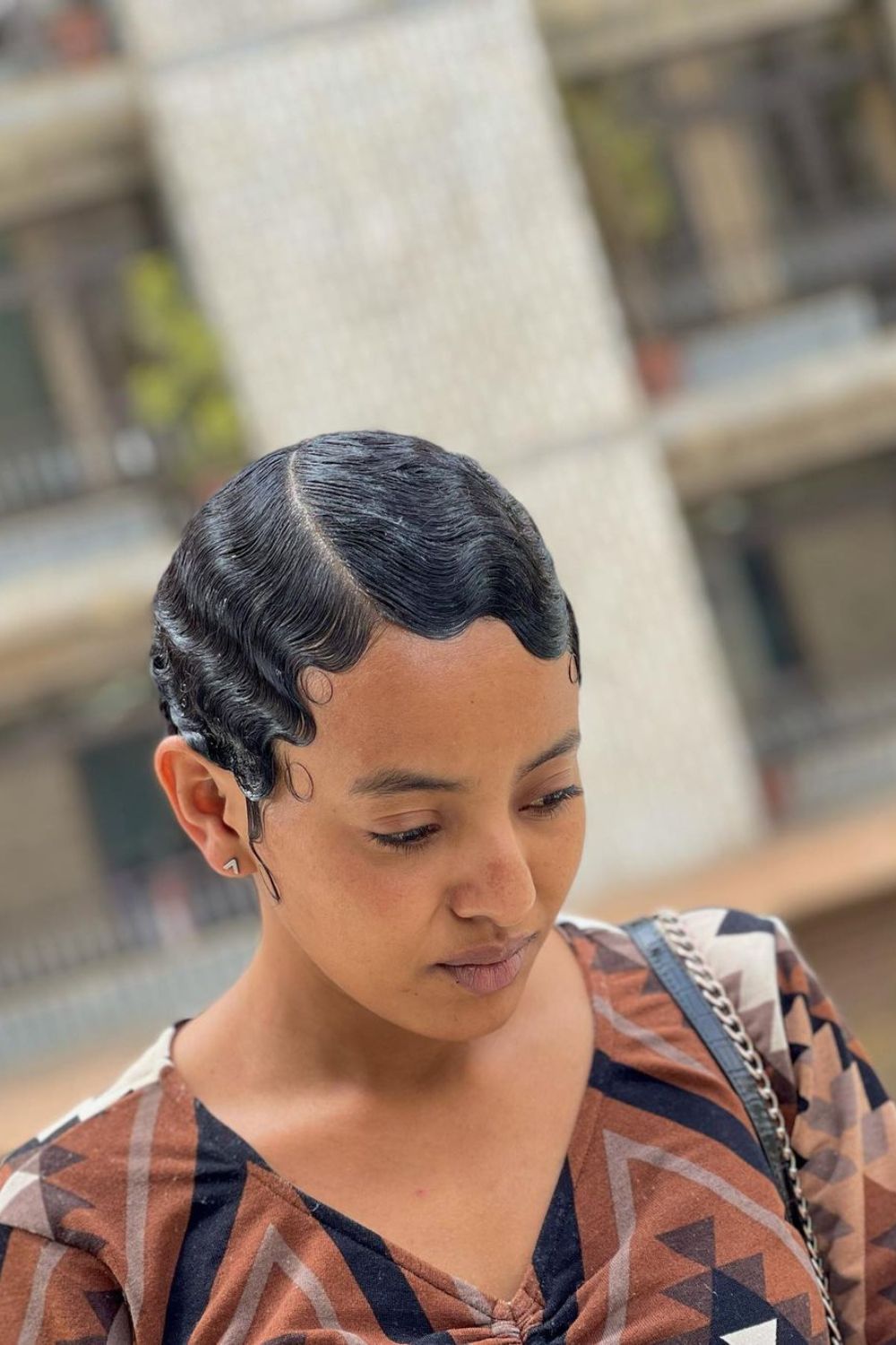 A woman with short black finger waves.