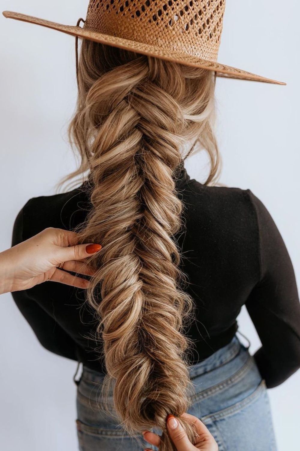 A woman with a long blonde fishtail braid.
