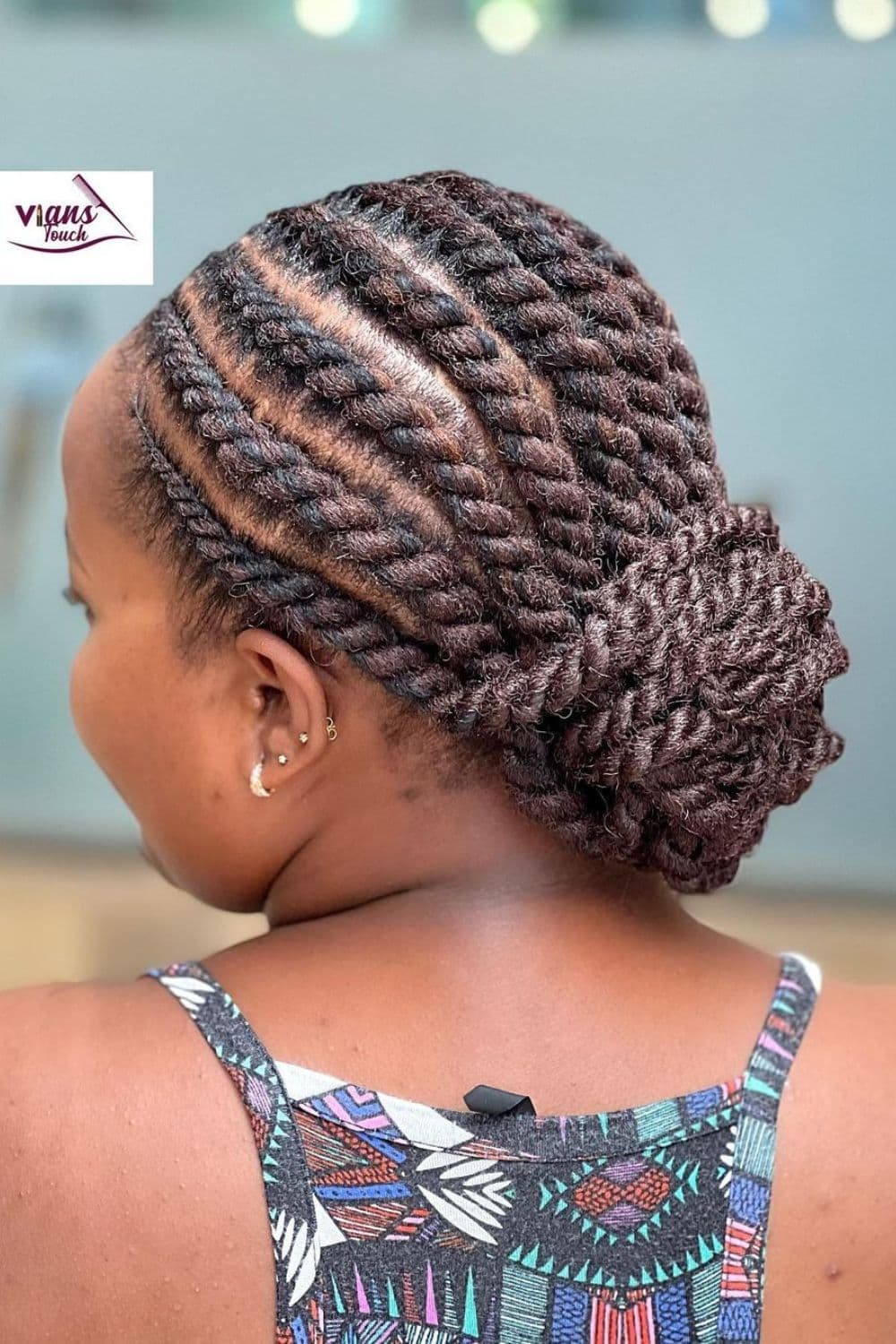 A woman with flat twists in a low bun.