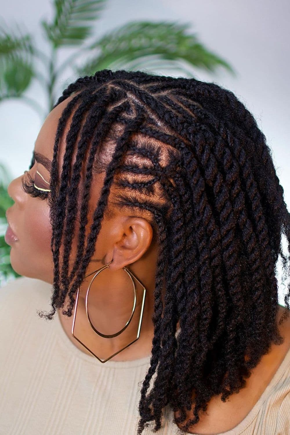 A woman with short black flat twists.