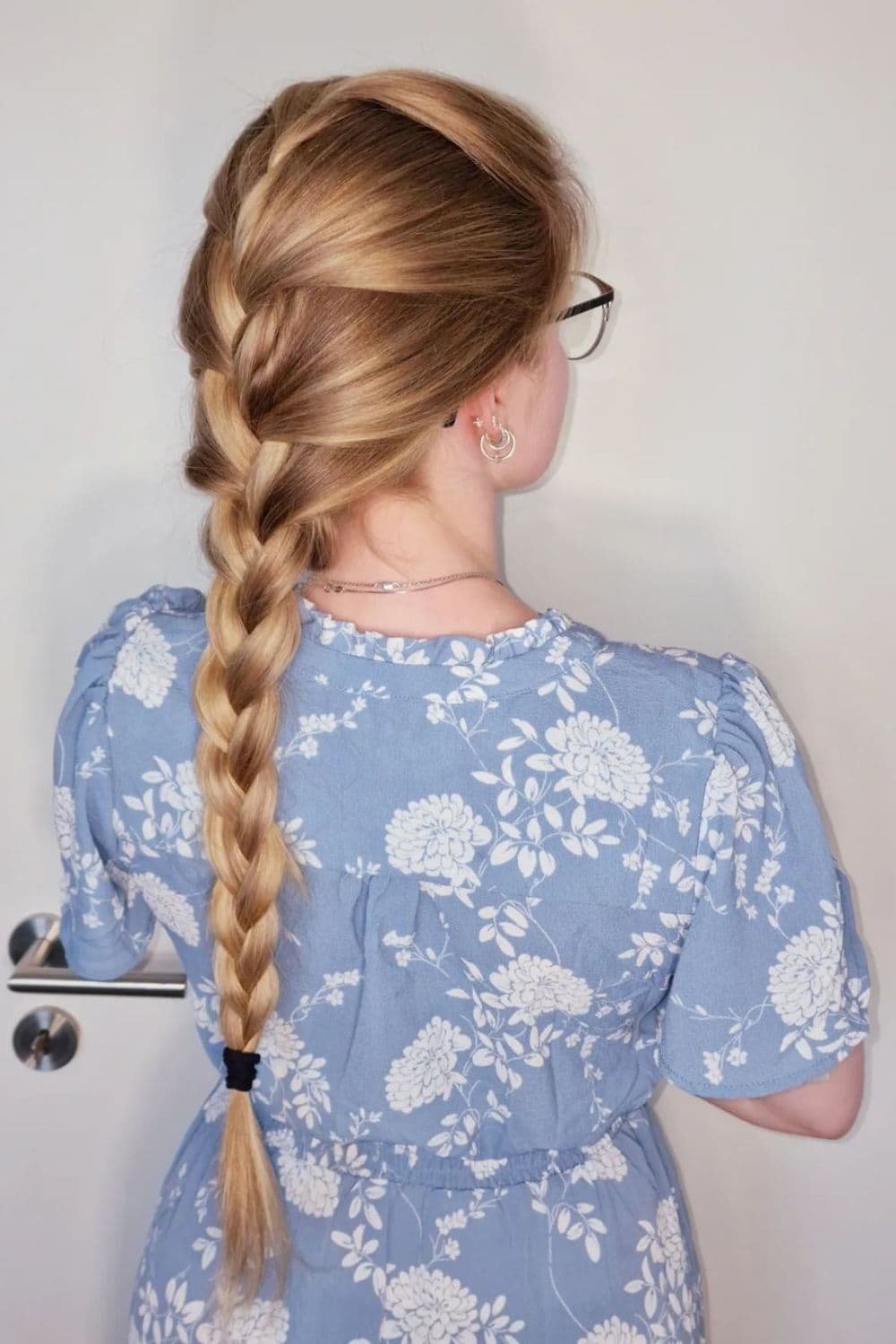 A woman with a long blonde French braid.