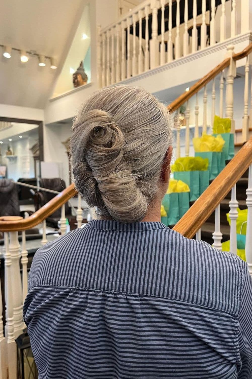 A woman with a gray French twist.