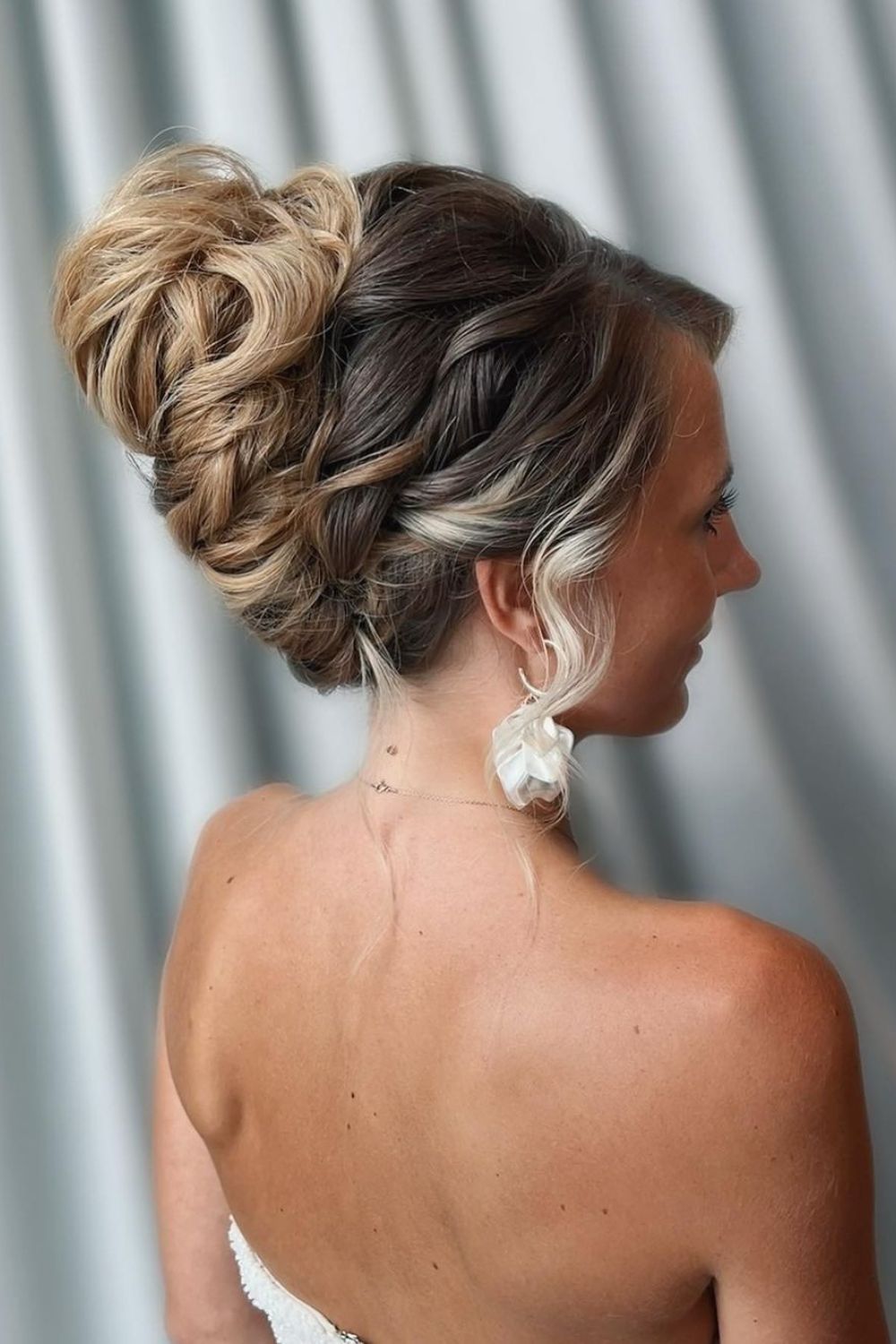 A woman with a blonde ombre French twist.