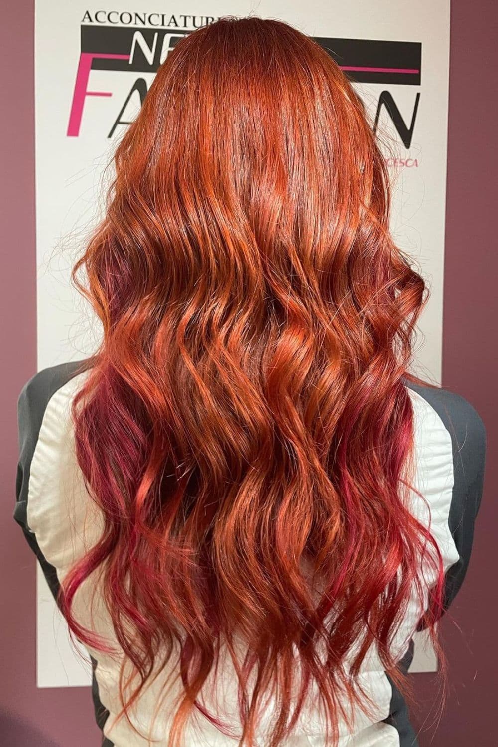 A woman with long ginger red hair with curls.