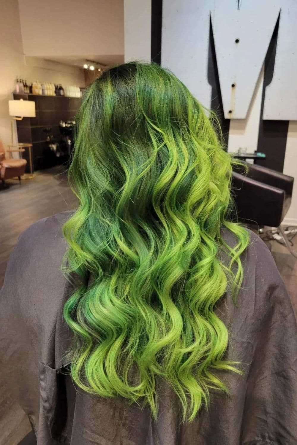A woman with a long green ombre hair.