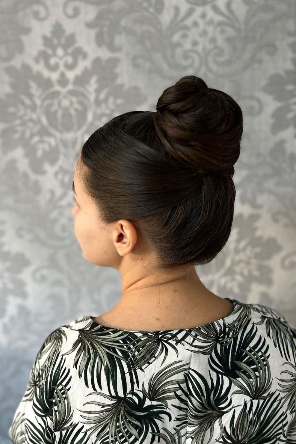 A woman with a high bun hairstyle.