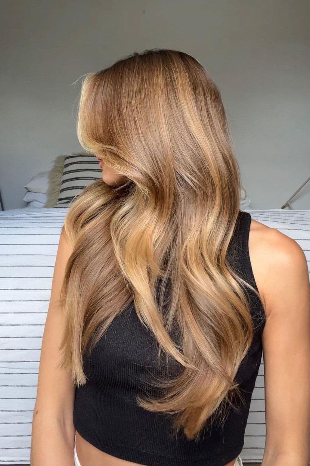 A woman with long honey dirty blonde with highlights.