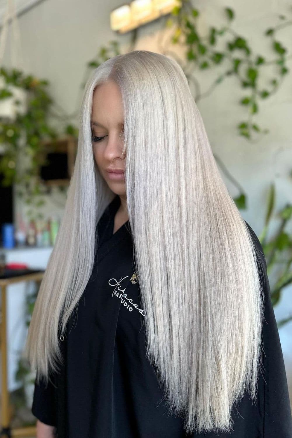 A woman with long straight icy platinum blonde hair.