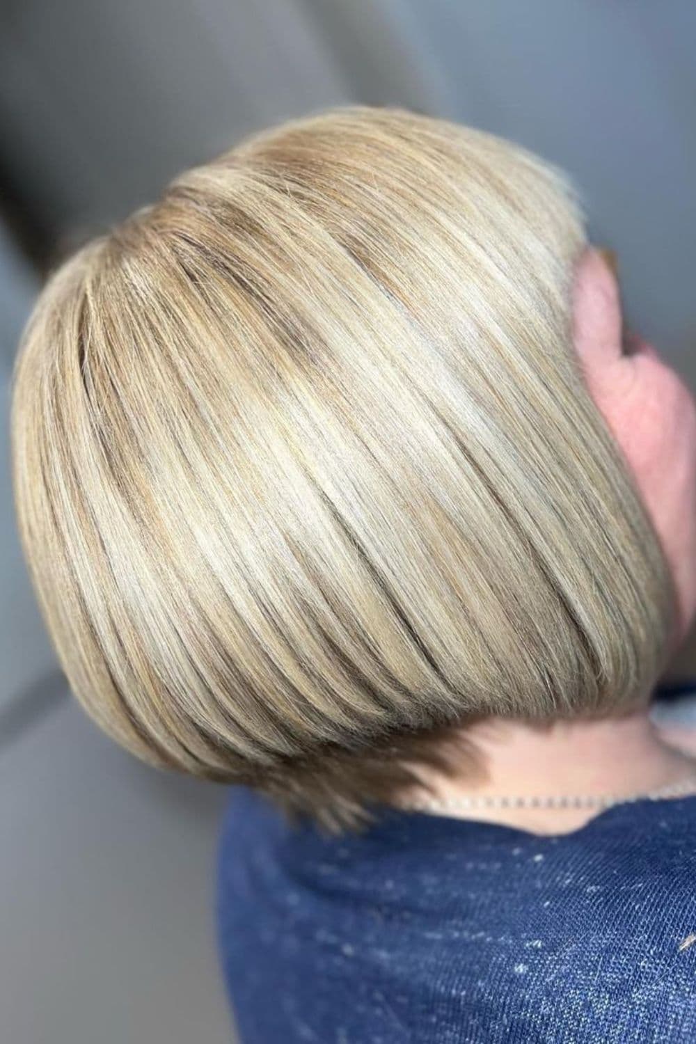 A woman with a blonde inverted bob cut.