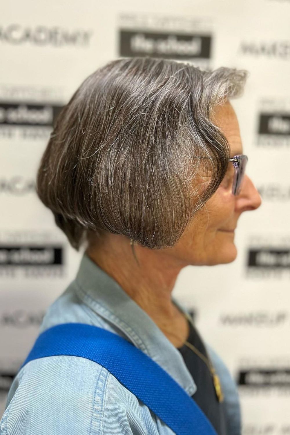 A woman with a gray jaw-length stacked bob cut.