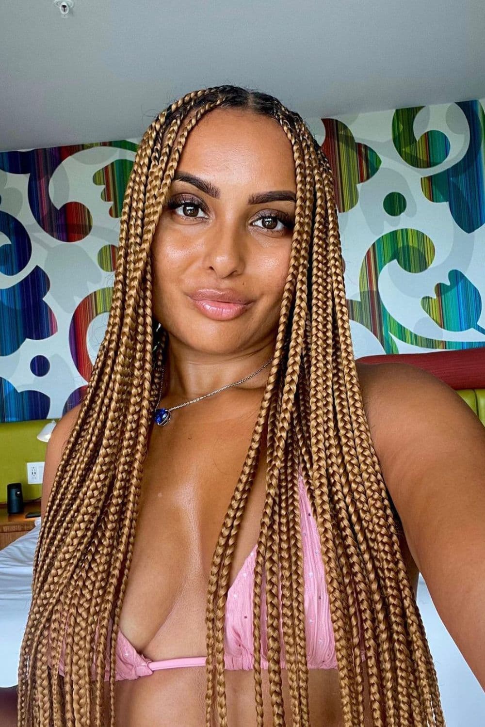 A woman with long brown knotless box braids.