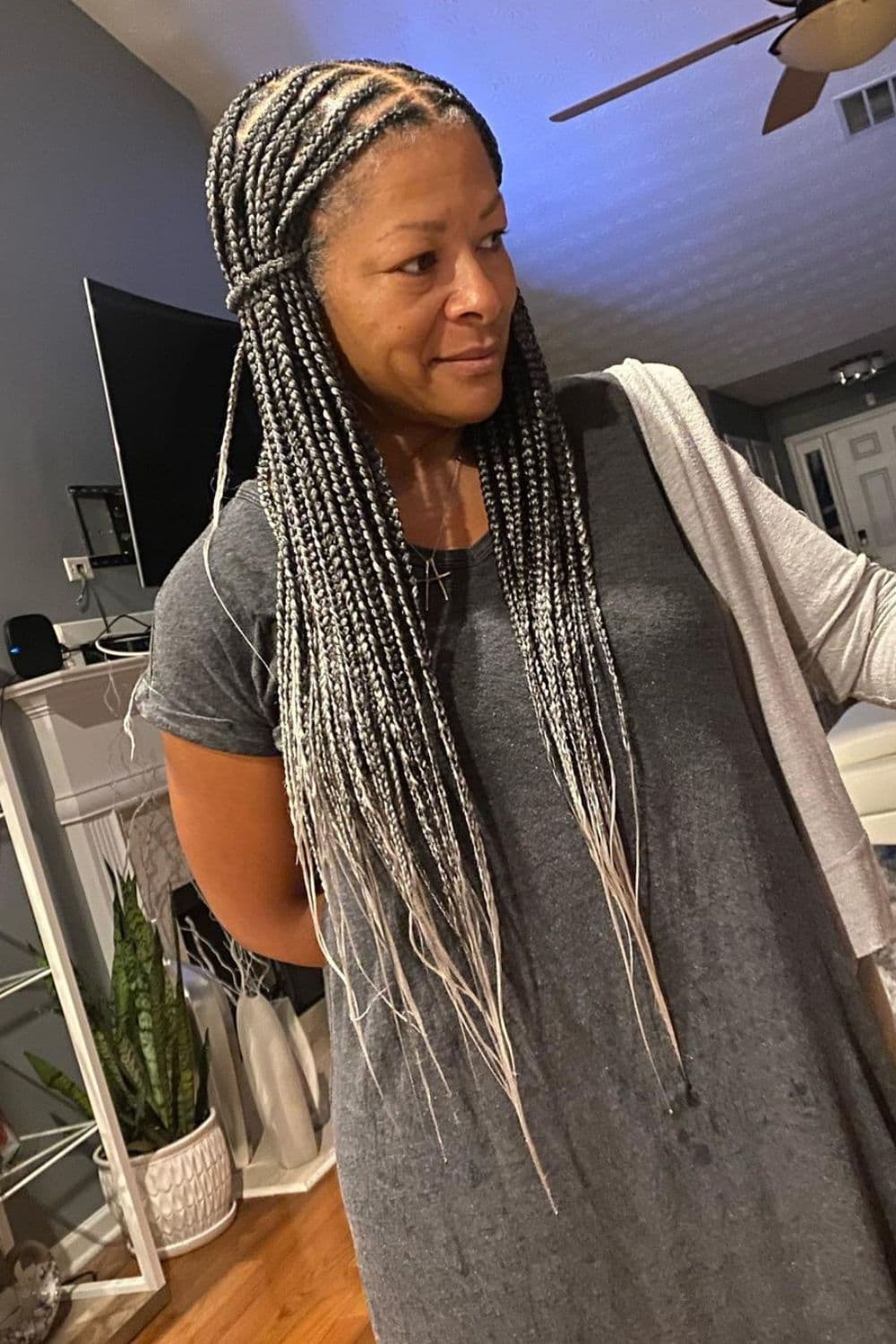 A woman with long gray knotless braids.
