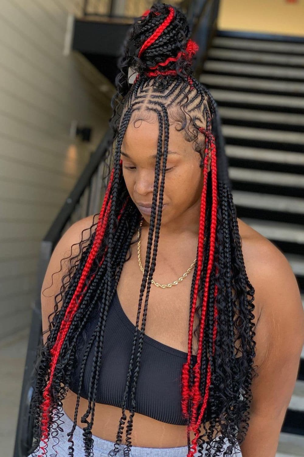A woman with long black and red knotless braids.